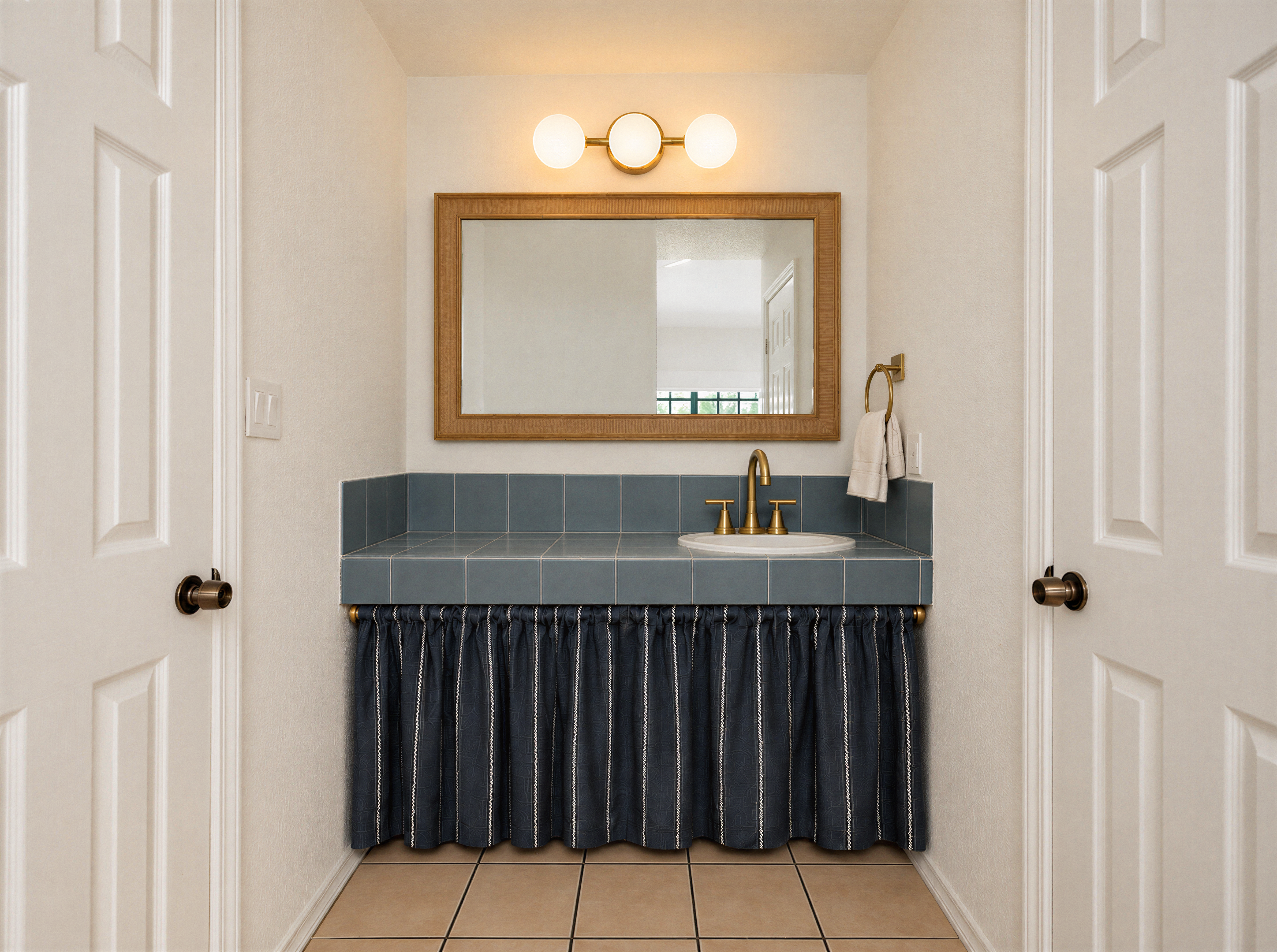 Deluxe King room with a navy headboard and a view into the vanity