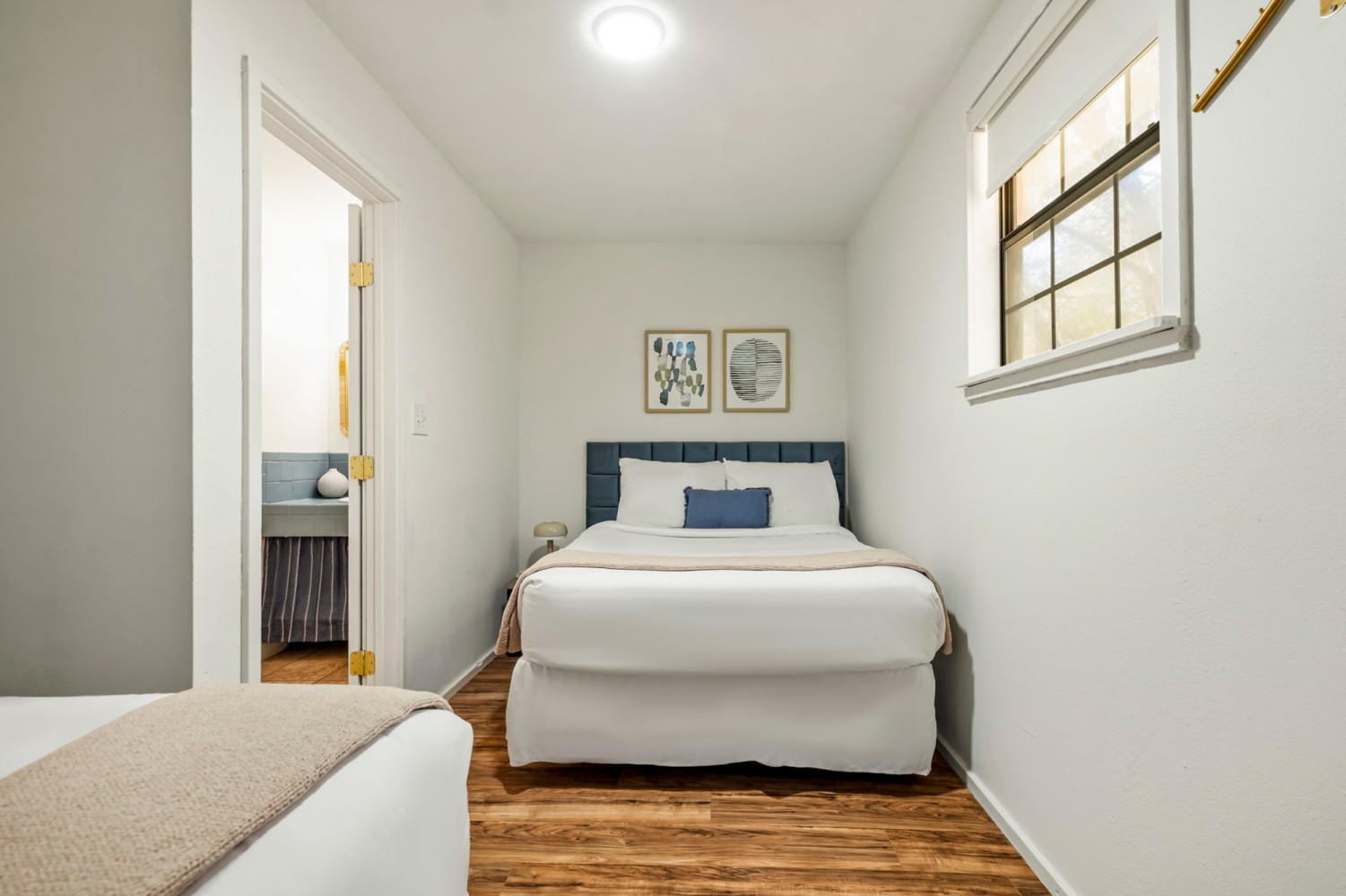 One Bedroom Suite bedroom with a queen bed and window