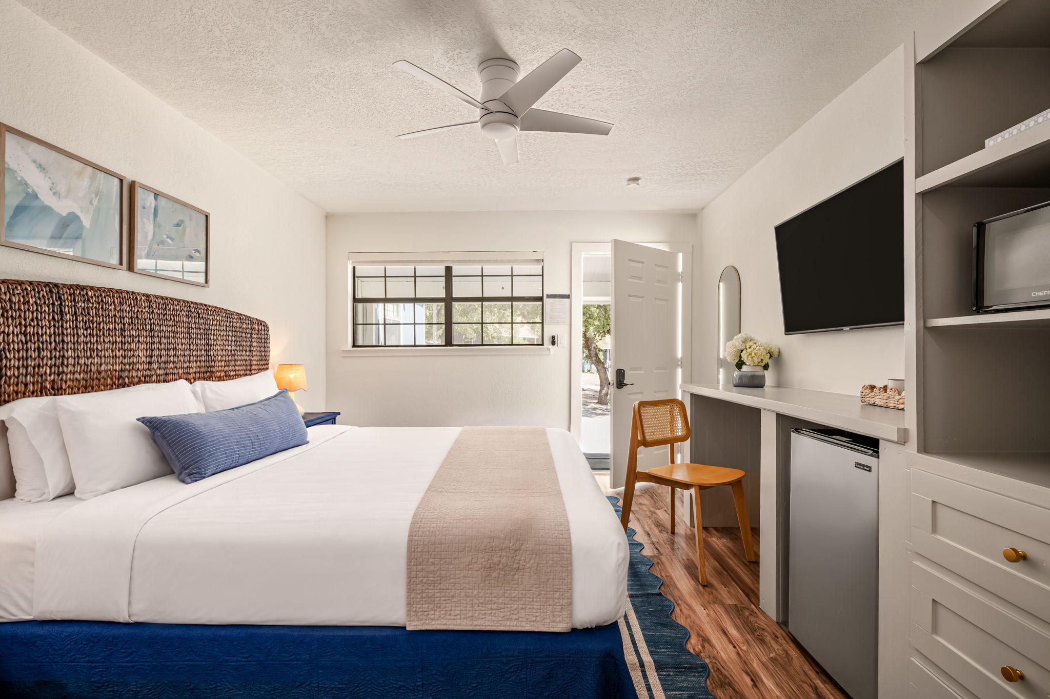 Standard King room with a king bed and wood floors