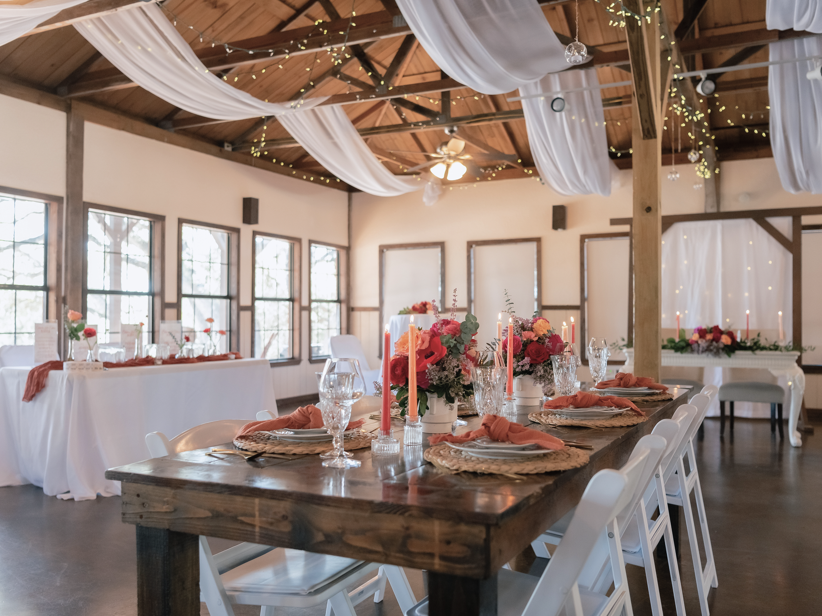 A reception table set in the hall with coral florals