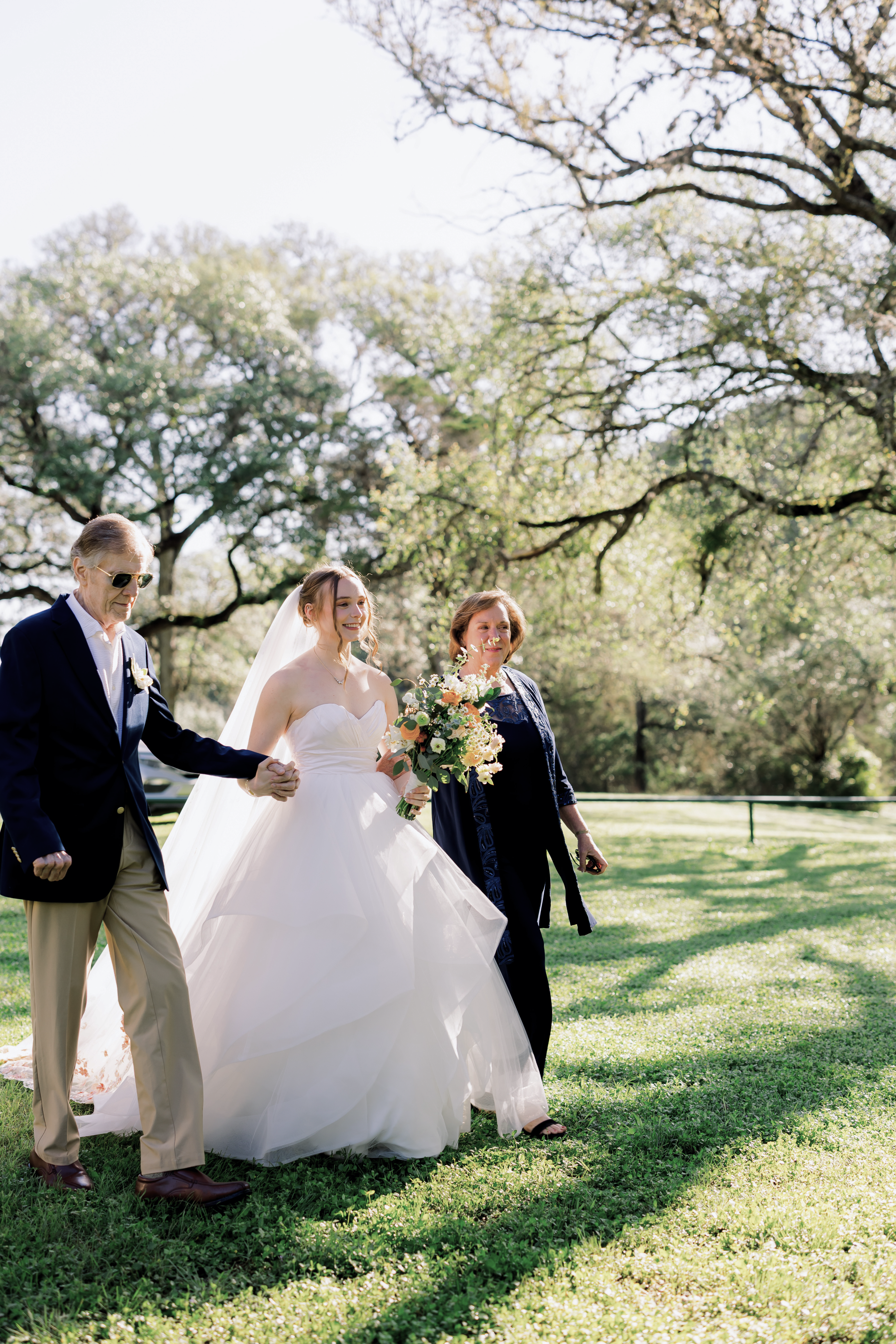 The bride walked down the aisle by her parents