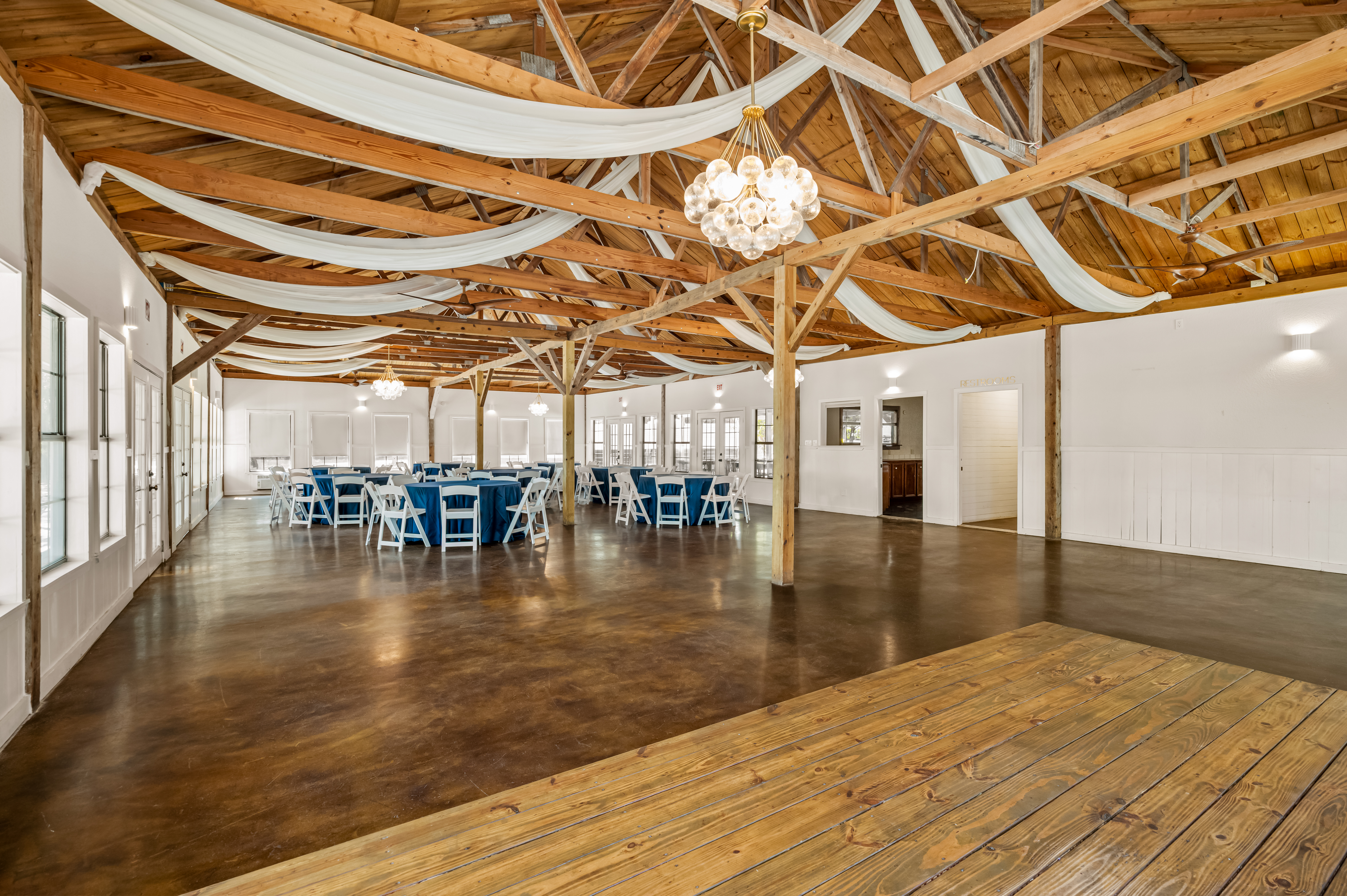 The open hall floor with its wooden dance floor and draped ceiling