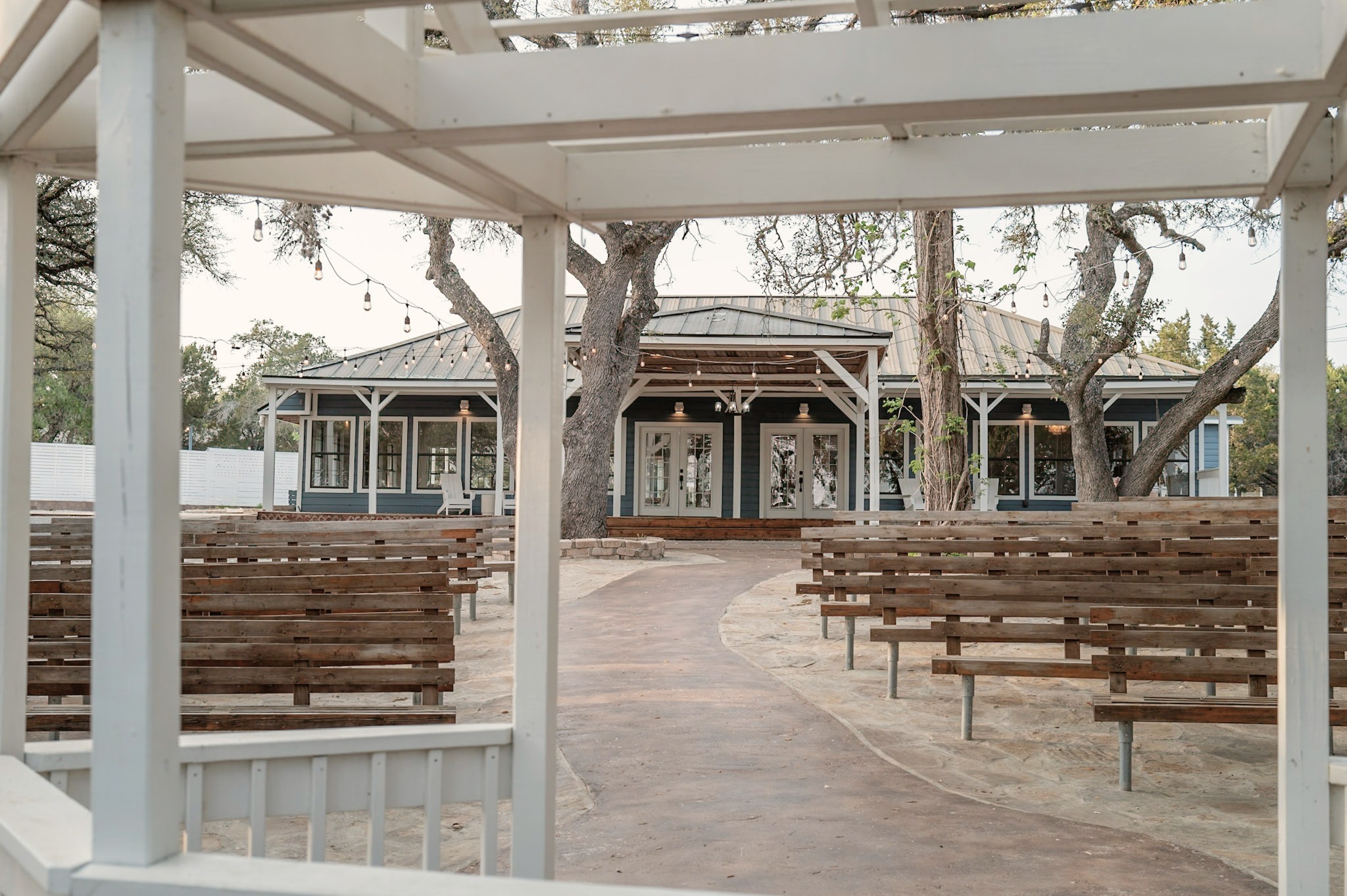 The hall seen from the gazebo, benches set along the path