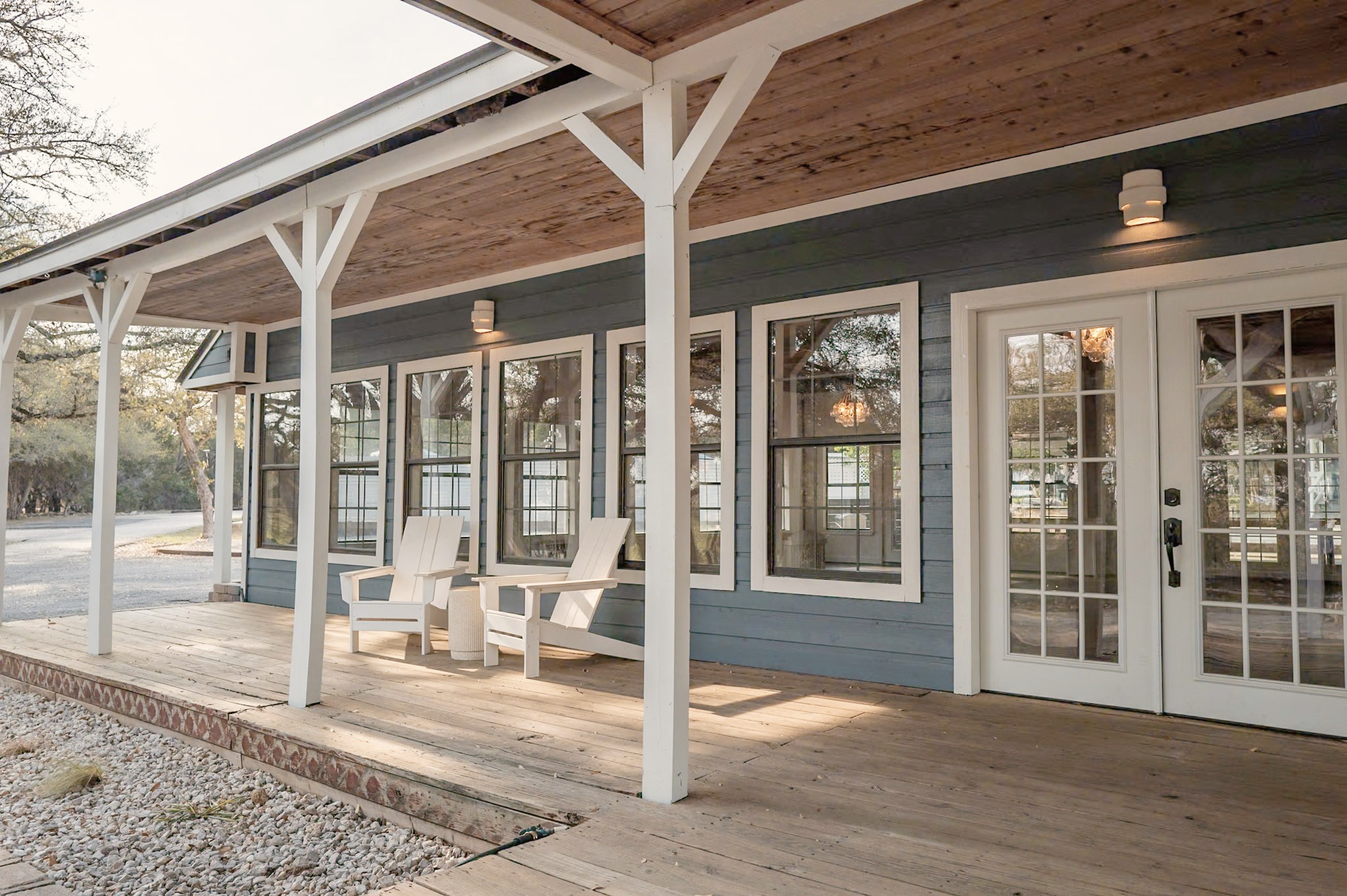 Adirondack chairs on the hall's wraparound porch in late light