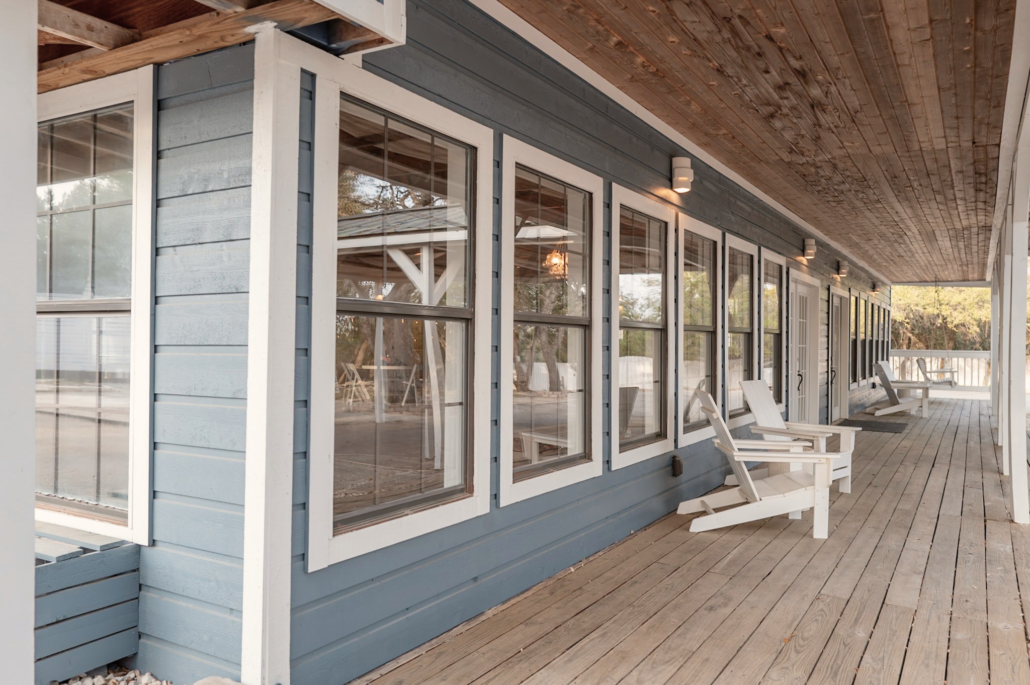 The porch running the length of the hall's window wall